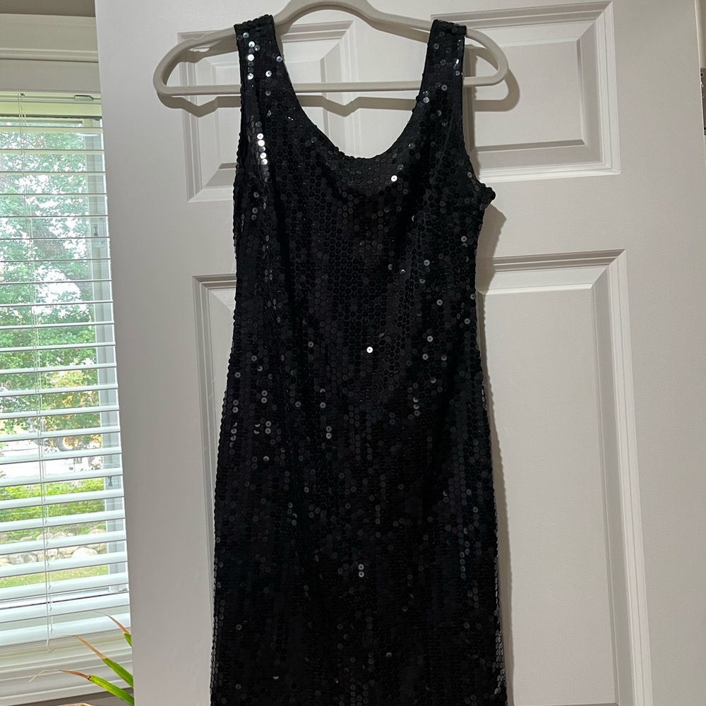 Cute unlined sequin mini dress. It has a scoop neck and back.